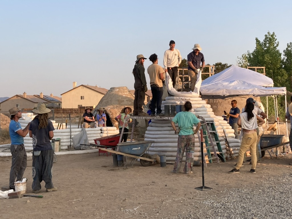 Participants building a SuperAdobe structure during a CalEarth workshop